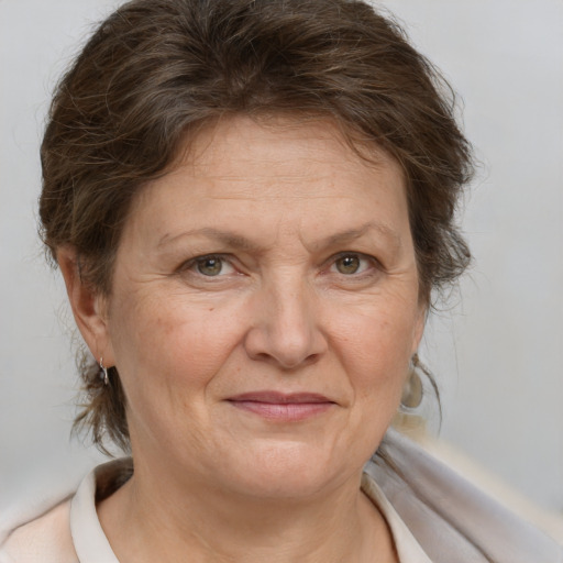 Joyful white middle-aged female with medium  brown hair and brown eyes