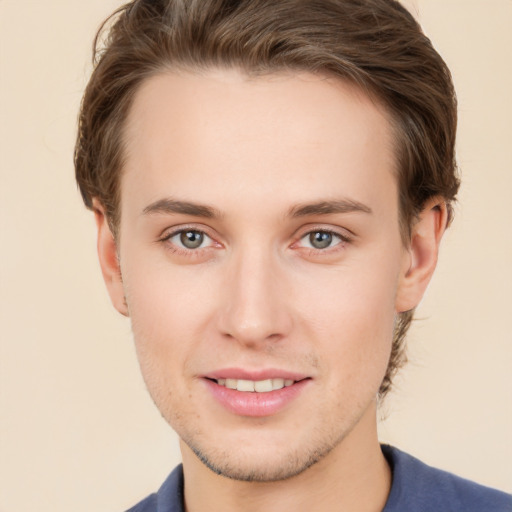 Joyful white young-adult male with short  brown hair and grey eyes