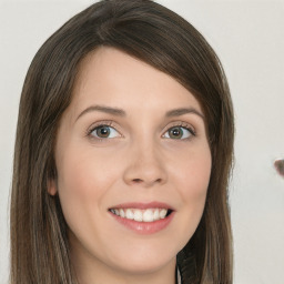 Joyful white young-adult female with long  brown hair and green eyes