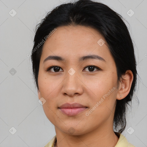 Joyful asian young-adult female with medium  black hair and brown eyes