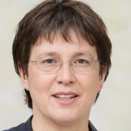 Joyful white adult female with medium  brown hair and grey eyes