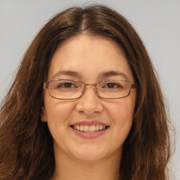 Joyful white adult female with long  brown hair and brown eyes