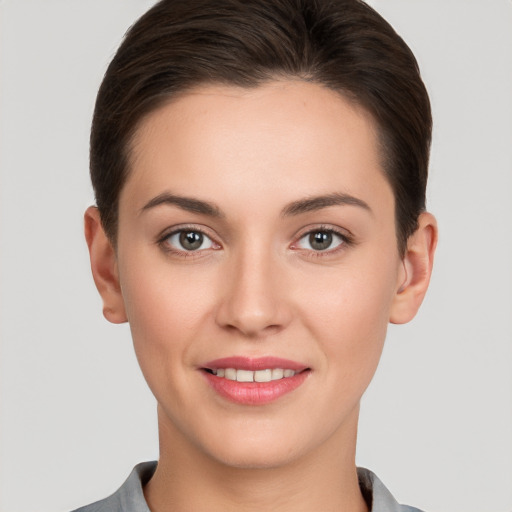 Joyful white young-adult female with short  brown hair and brown eyes