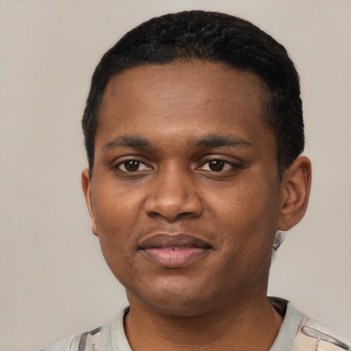 Joyful black young-adult male with short  black hair and brown eyes