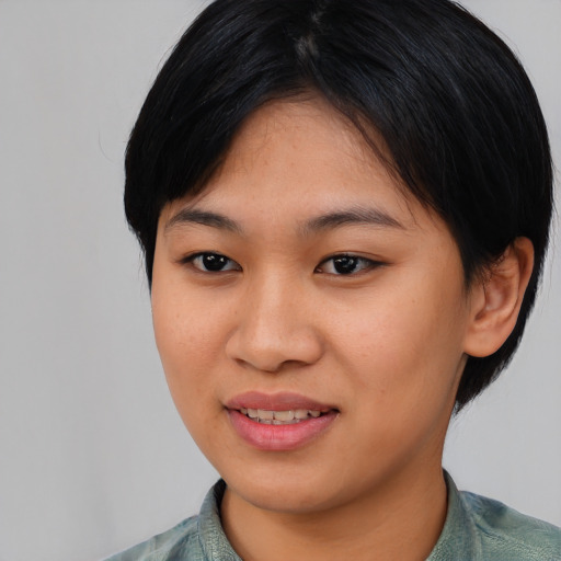 Joyful asian young-adult female with medium  black hair and brown eyes