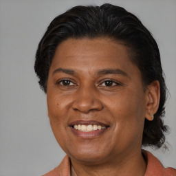 Joyful latino adult female with medium  brown hair and brown eyes