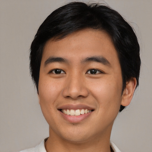 Joyful asian young-adult male with medium  black hair and brown eyes