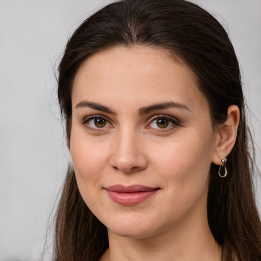 Joyful white young-adult female with long  brown hair and brown eyes