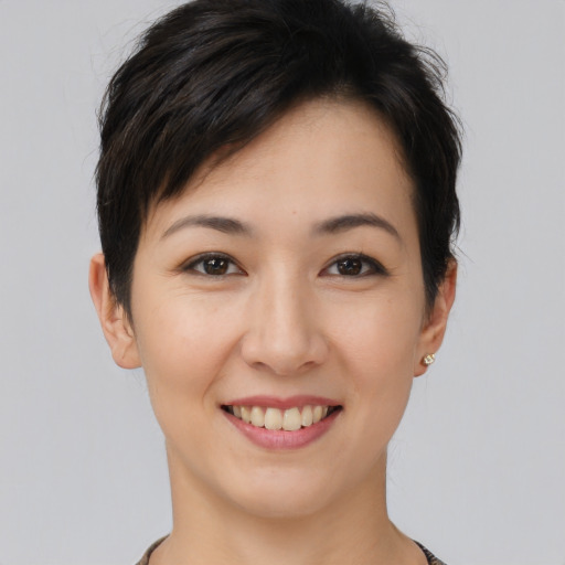 Joyful asian young-adult female with short  brown hair and brown eyes