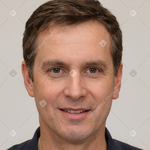 Joyful white adult male with short  brown hair and grey eyes