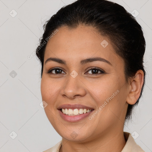 Joyful latino young-adult female with medium  brown hair and brown eyes