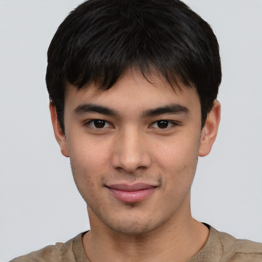 Joyful asian young-adult male with short  brown hair and brown eyes