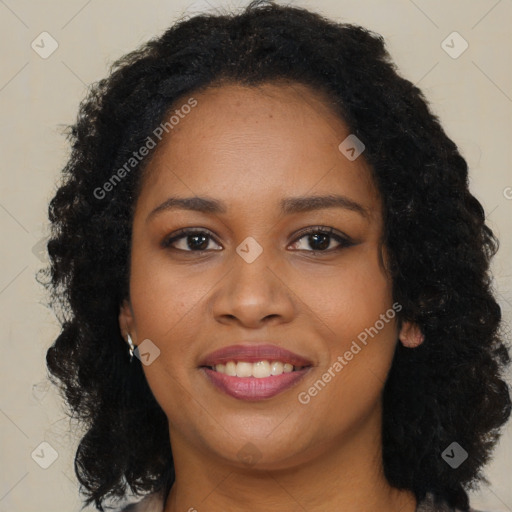 Joyful black young-adult female with long  brown hair and brown eyes