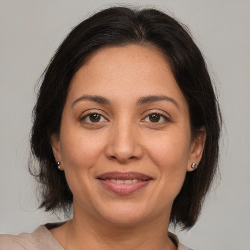 Joyful white adult female with medium  brown hair and brown eyes