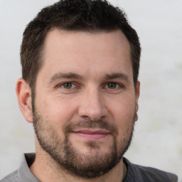 Joyful white adult male with short  brown hair and brown eyes