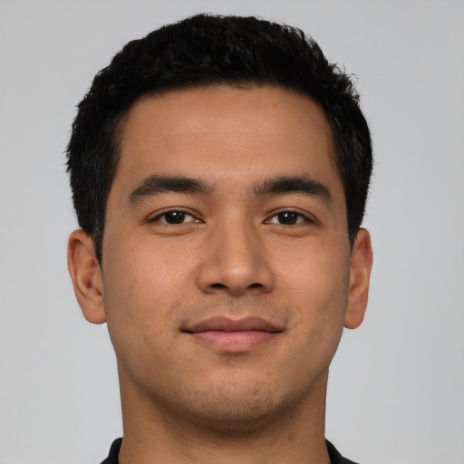 Joyful latino young-adult male with short  brown hair and brown eyes