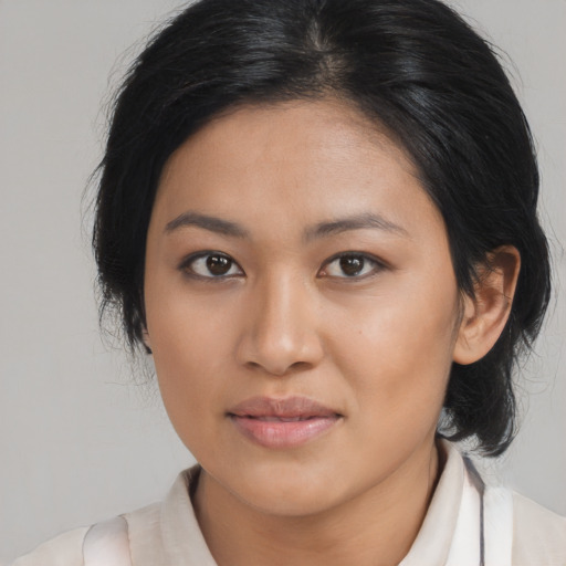 Joyful asian young-adult female with medium  brown hair and brown eyes