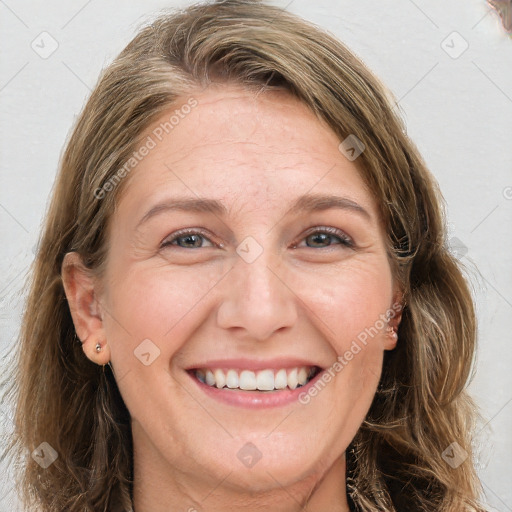 Joyful white adult female with long  brown hair and grey eyes