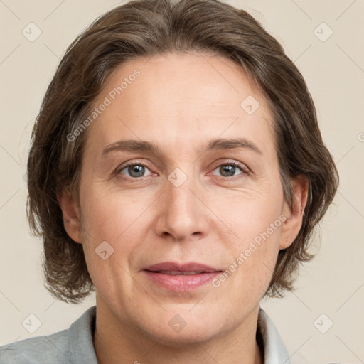 Joyful white adult female with medium  brown hair and grey eyes