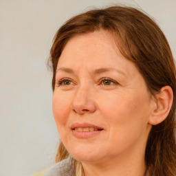 Joyful white adult female with long  brown hair and brown eyes