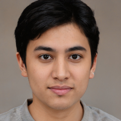 Joyful latino young-adult male with short  brown hair and brown eyes