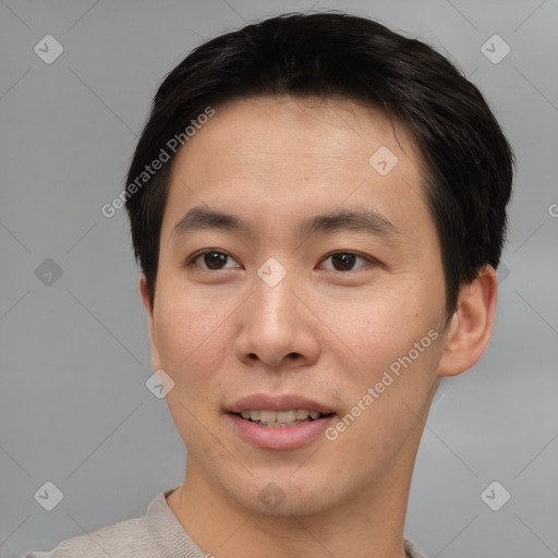 Joyful asian young-adult male with short  brown hair and brown eyes