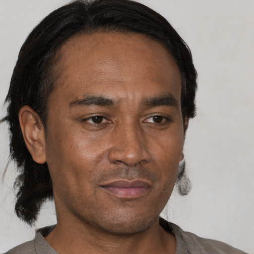 Joyful black adult male with short  black hair and brown eyes