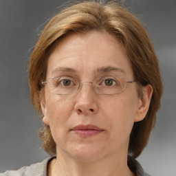 Joyful white adult female with medium  brown hair and blue eyes