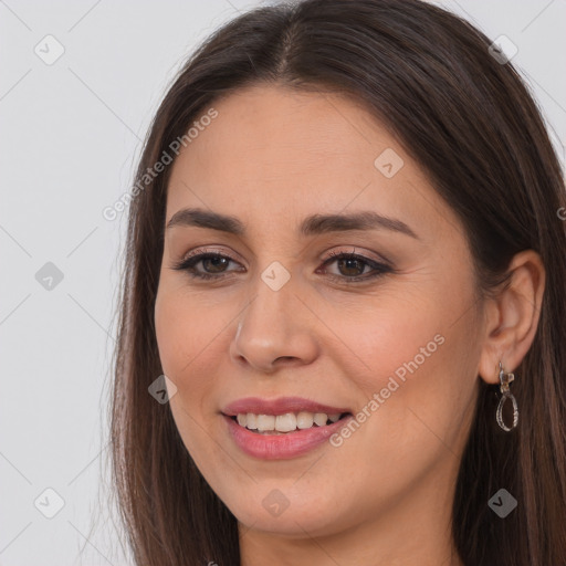 Joyful white young-adult female with long  brown hair and brown eyes