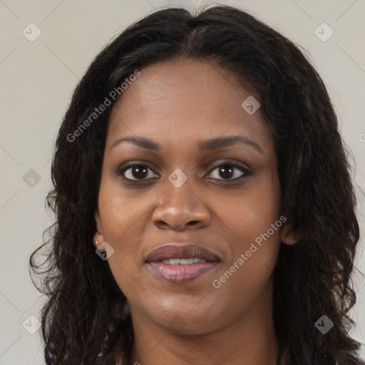 Joyful black young-adult female with long  brown hair and brown eyes