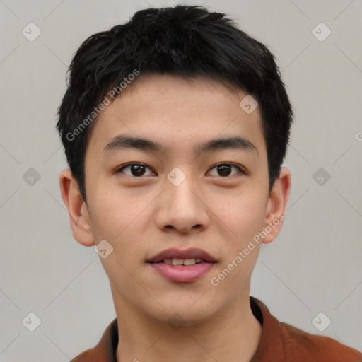 Joyful asian young-adult male with short  black hair and brown eyes