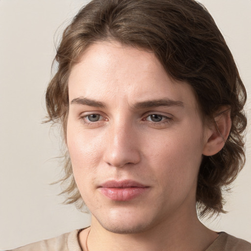 Joyful white young-adult male with medium  brown hair and grey eyes