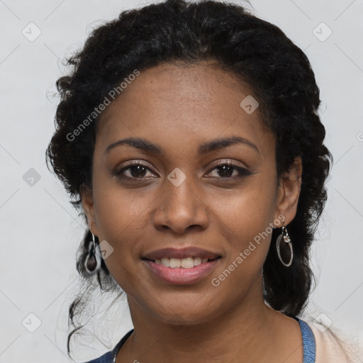 Joyful black young-adult female with long  black hair and brown eyes