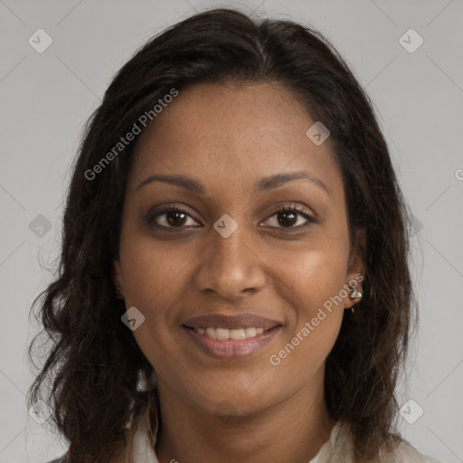 Joyful black young-adult female with long  brown hair and brown eyes