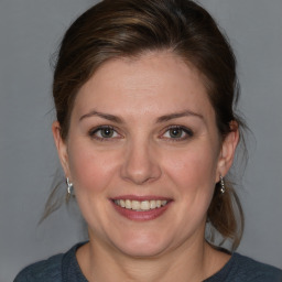 Joyful white adult female with medium  brown hair and grey eyes