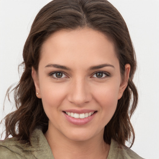 Joyful white young-adult female with medium  brown hair and grey eyes