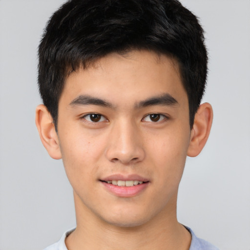 Joyful asian young-adult male with short  brown hair and brown eyes