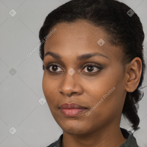 Joyful black young-adult female with short  black hair and brown eyes