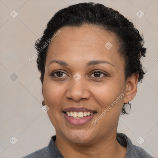 Joyful latino adult female with short  brown hair and brown eyes