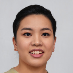 Joyful asian young-adult female with short  black hair and brown eyes