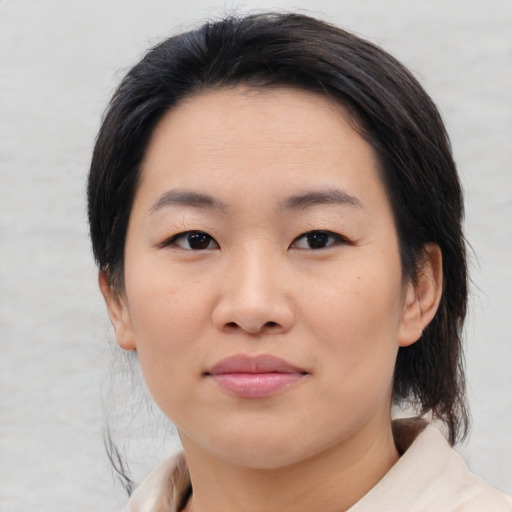Joyful asian young-adult female with medium  black hair and brown eyes