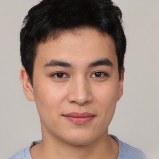 Joyful asian young-adult male with short  brown hair and brown eyes