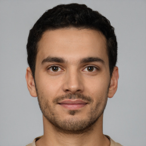 Joyful latino young-adult male with short  brown hair and brown eyes