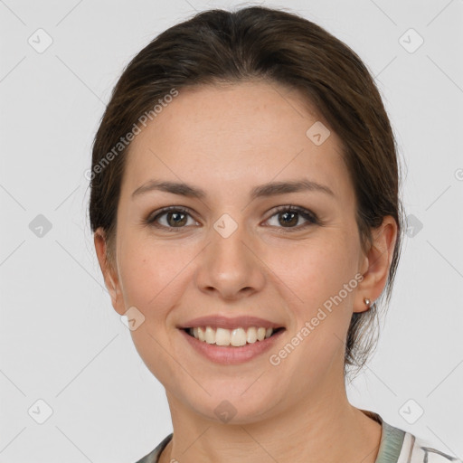 Joyful white young-adult female with medium  brown hair and grey eyes