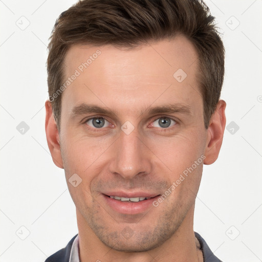 Joyful white young-adult male with short  brown hair and grey eyes