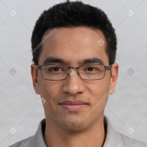 Joyful white young-adult male with short  black hair and brown eyes