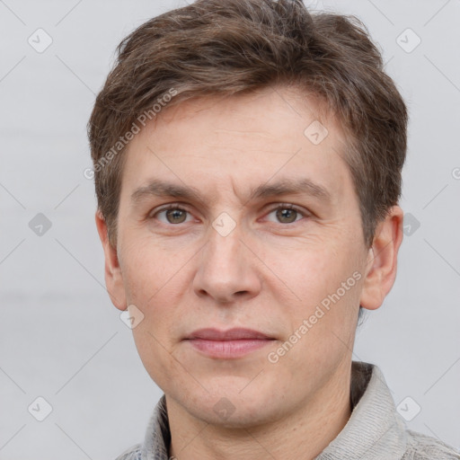 Joyful white adult male with short  brown hair and grey eyes