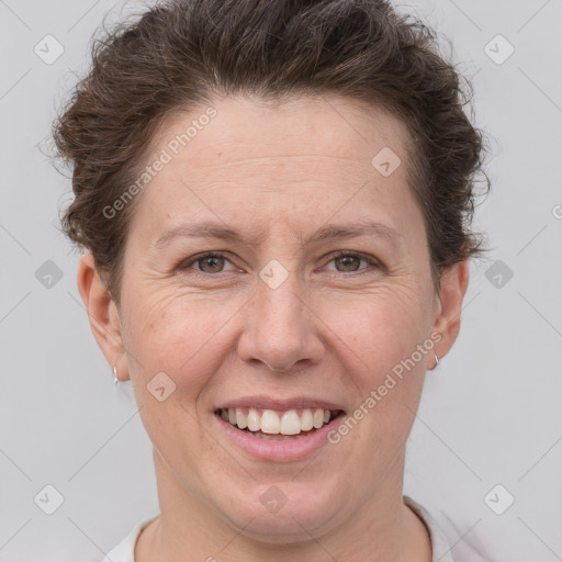 Joyful white adult female with short  brown hair and brown eyes