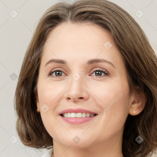 Joyful white young-adult female with medium  brown hair and green eyes