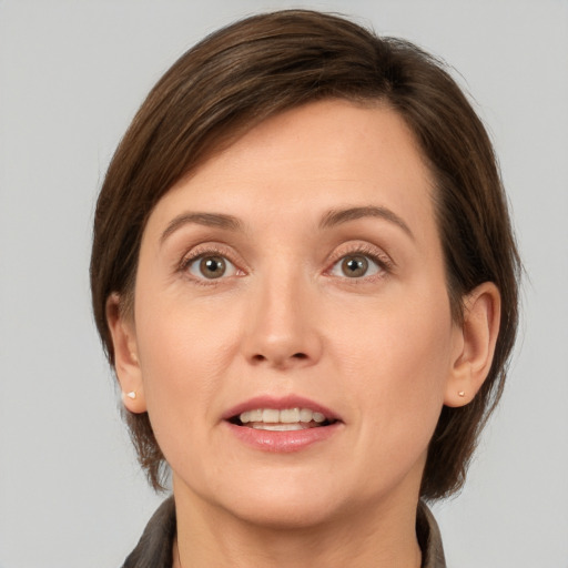 Joyful white young-adult female with medium  brown hair and grey eyes